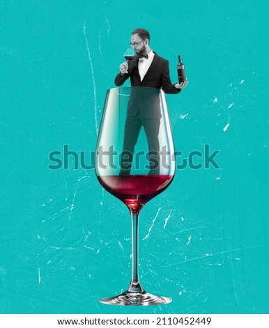 Degustation, tasting. Contemporary art collage, modern design. Party vibe, mood. Young man in black suit into red wine glass isolated on blue background. Surrealism. Copy space for ad, text.