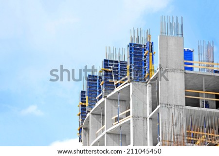 Building construction site work against blue sky Royalty-Free Stock Photo #211045450