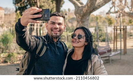 woman and man taking a selfie on a trip
