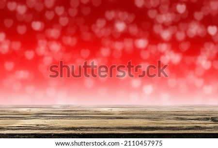 Empty white wooden table on red heart blurry bokeh abstract background. Valentine day concept web banner advertising.