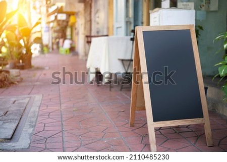 Restaurant sidewalk chalkboard sign board. empty black board (menu board) at a restaurant with space for text