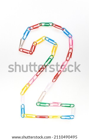 Figure number two from colored school paper clips on a white background Royalty-Free Stock Photo #2110490495