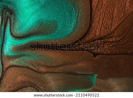 Abstract background from shimmer nail lacquer,chocolate and turquoise colors.Selective focus.