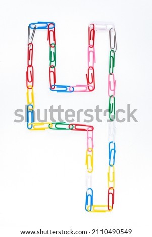 Figure number four from colored school paper clips on a white background Royalty-Free Stock Photo #2110490549
