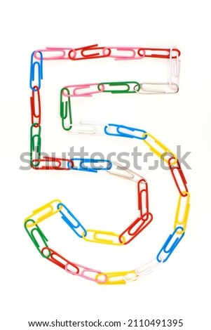 Figure number five from colored school paper clips on a white background Royalty-Free Stock Photo #2110491395