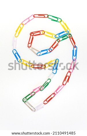 Figure number nine from colored school paper clips on a white background Royalty-Free Stock Photo #2110491485