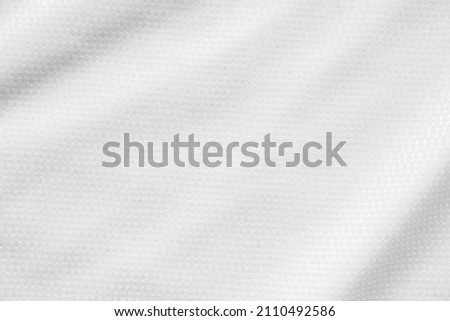 White sports clothing fabric football shirt jersey texture background Royalty-Free Stock Photo #2110492586