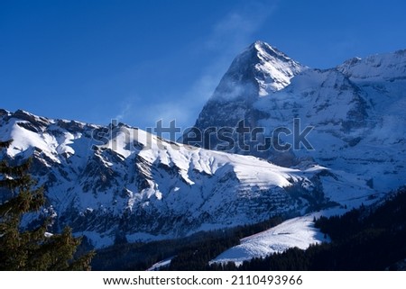 Beautiful mountain panorama at the Swiss Alps with Eiger peak and glacier seen from Winteregg Mürren on a sunny winter day. Photo taken January 15th, 2022, Lauterbrunnen, Switzerland.