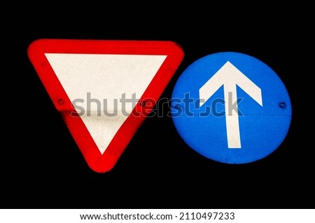 Two old dirty traffic signs isolated  on black