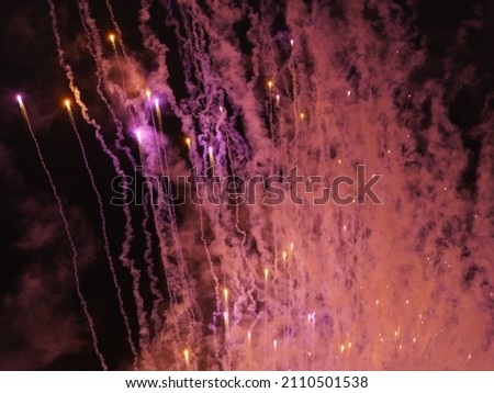 Defocused colorful Christmas lights photography. Bright pink fireworks on New Year's Eve on a city street. Celebration of New Year 2020 in VDNkH in night. Holidays and lifestyles concepts.