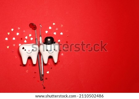 dentist. Valentine's Day. dentist tools. dentistry. dental concept .teeth .red background. hearts. Royalty-Free Stock Photo #2110502486