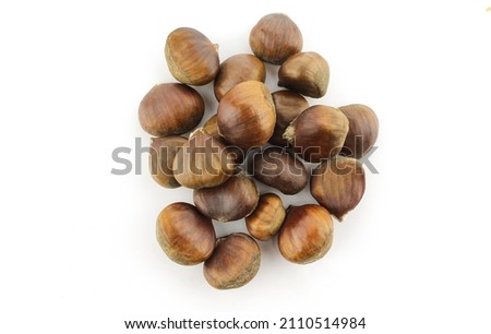 Pile of brown dry chestnuts isolated on white background