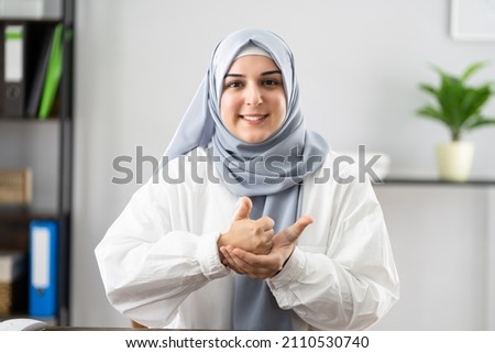 Happy Woman Wearing Hijab Learning Sign Language