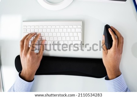 African American Man With Wrist Pain Using Ergonomic Vertical Mouse Royalty-Free Stock Photo #2110534283