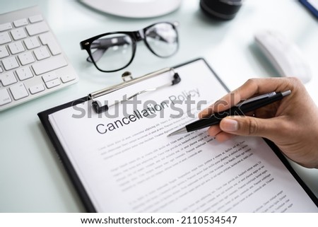 African Man Reading Business Cancel Policy And Regulation Royalty-Free Stock Photo #2110534547