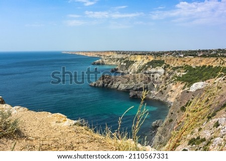 Cape Fiolent in Balaklava, Russia. View from the top of the cliff. azure sea, sunny day against a clear sky. Rock monk, Cape Fiolent, Sevastopol, Crimea.