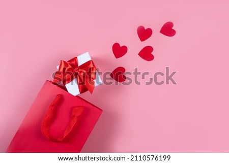Flat lay. Packaging for purchases, gifts and parcels on a pink background. The concept of delivery of gifts and parcels for the holidays valentines day, pleasant surprises. Shopping, sale, promotion.