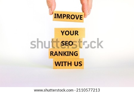 Improve your SEO ranking with us symbol. Wooden blocks with words Improve your SEO ranking with us. Businessman icon. Beautiful white background, copy space. Business, improve SEO ranking concept. Royalty-Free Stock Photo #2110577213