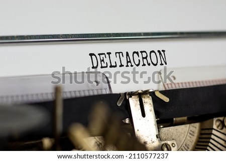 Covid-19 corona deltacron symbol. The concept word Deltacron typed on retro typewriter. Beautiful white background. Medical, covid-19 corona deltacron variant concept. Copy space.