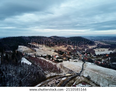 Winter landscape with mountains and village, aerial view. Nature panorama