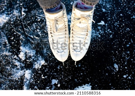 close-up of women's legs in white figure skating skates. top view
