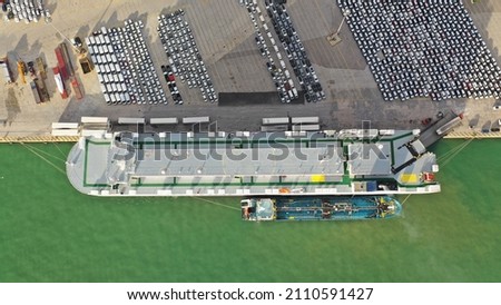 Aerial drone top down photo of large car carrier ro ro vessel anchored in car terminal of Mediterranean port Royalty-Free Stock Photo #2110591427