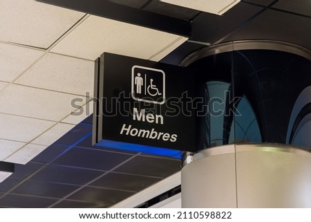 Airport terminal with toilet man signs on black