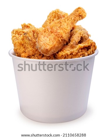 Fried chicken in paper bucket isolated on white background, Fried chicken on white With clipping path. Royalty-Free Stock Photo #2110658288