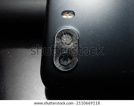 Close up shoot of broken mobile phone camera. shoot on black background