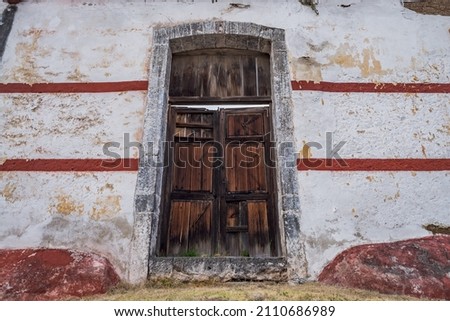 Adobe wall with a old wooden door at an old Mexican Hacienda