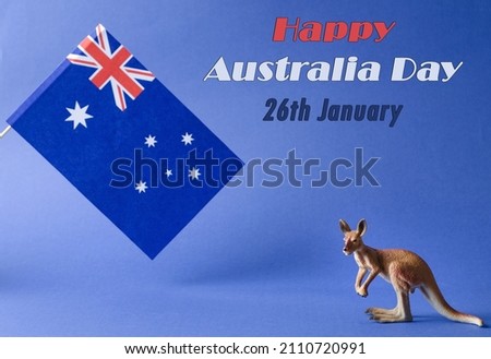January 26 is Australia Day or Anzac Day. National flag and kangaroo figurine on a blue background with the inscription of the Happy Day of Australia on 26 January