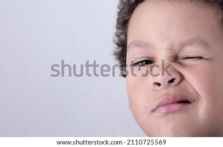 little boy winking with white background stock photo