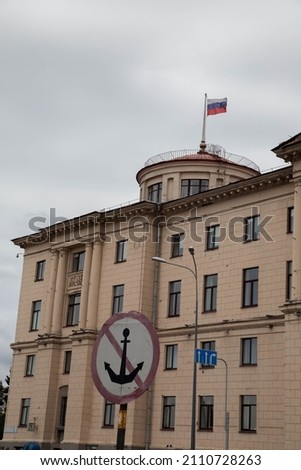 A building with a Russian flag and a mooring sign is prohibited