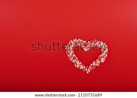 red and white heart on a red background