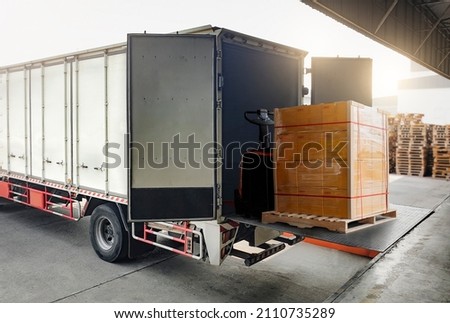 Cargo Truck Container Loading Packaging Boxes at Dock Warehouse. Slider Lift for Truck. Cargo Shipment. Delivery Supply Chain. Lorry. Warehouse Shipping. Industry Freight Truck Transport Logistics.	 Royalty-Free Stock Photo #2110735289