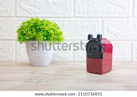 Pencil sharpener on a background with a flower