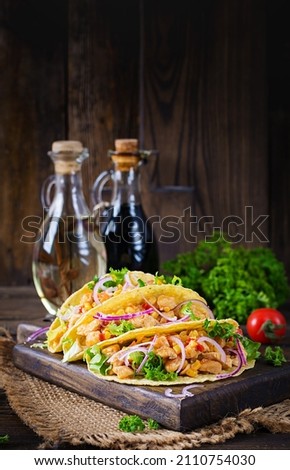 Mexican tacos with chicken meat, vegetables and red onion. Mexican taco.