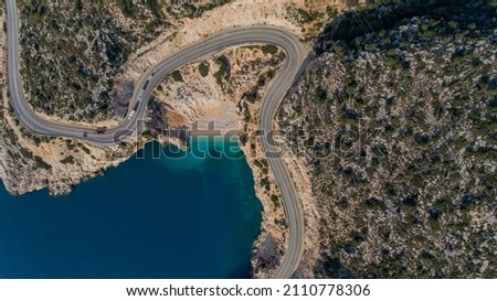 Birds eye view of coastline and a road seascape. Empty asphalt road along the sunny Mediterranean shoreline of Turkey. 