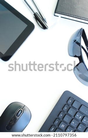 Flat lay photo of office desk with laptop, smartphone, eyeglasses and notebook with copy space background.