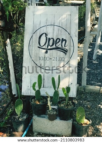 An open storefront sign to tell customers that the store is open for business.
