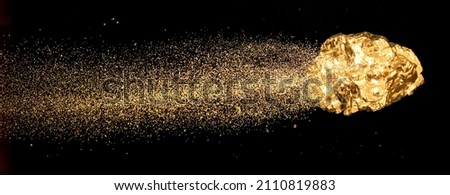 Piece of gold or golden nugget with visible gold shining comet tail ath the dark background.  Royalty-Free Stock Photo #2110819883