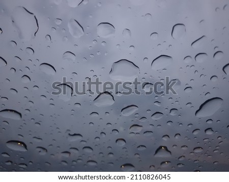 Beautiful picture of drops of rain on the car windshield in a season