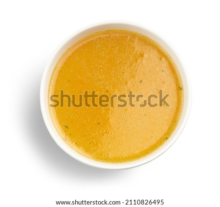 bowl of fresh chicken broth isolated on white background, top view