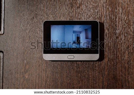 video screen of the peephole or intercom on the front door. video surveillance system for home. security. Royalty-Free Stock Photo #2110832525