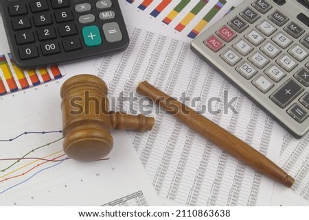 Broken judge gavel and calculators on financial documents. Wrong arbitration, audition and injustice concept. Royalty-Free Stock Photo #2110863638