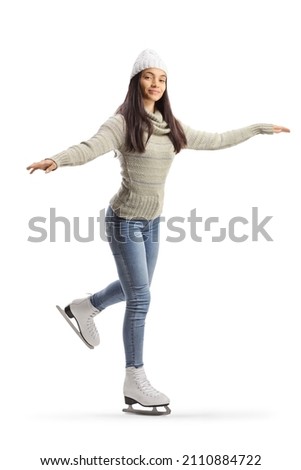 Bautiful young woman ice skating and looking at camera isolated on white background