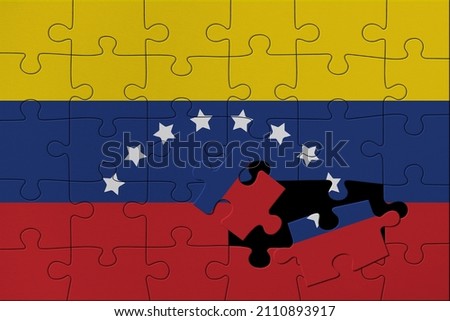 World countries. Broken puzzle- background in colors of national flag. Venezuela