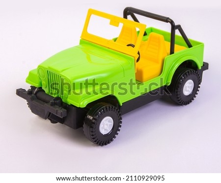 Children's toy multi-colored plastic cars on a white background. Toy vehicles, outdoor games for children.