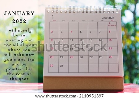 White January 2022 calendar on green background with motivational and inspirational quote