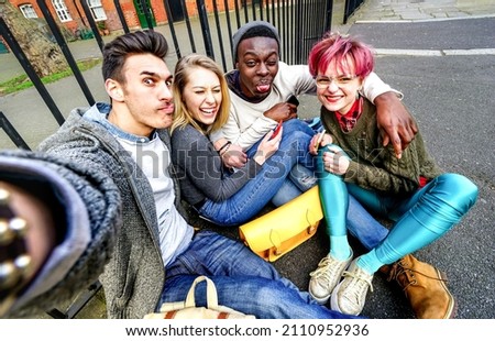 Multicultural hipster friends taking selfie in Shoreditch at european trip - Young people addicted by sharing stories on social network community - Millenials life style concept on bright vivid filter
